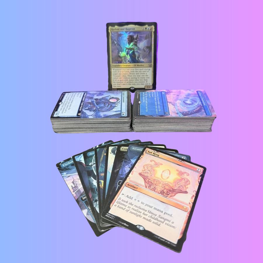 Rashmi and Ragavan above two printed Commander deck stacks, with custom cards fanned in front on a blue-to-purple background.